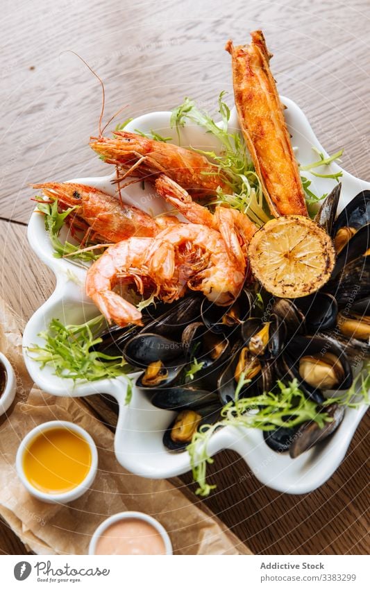 Seafood appetizer plate with assortment of sauces seafood prawn grill mussel delicacy culinary restaurant cafe delicious dish sweet chili sauce thousand island