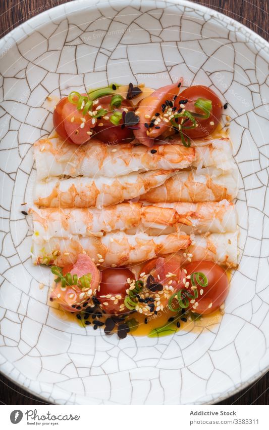 Appetizing seafood with tomatoes and herbs in ornamental plate shrimp sesame seed tasty fresh delicious gourmet dish cuisine condiment lunch portion yummy