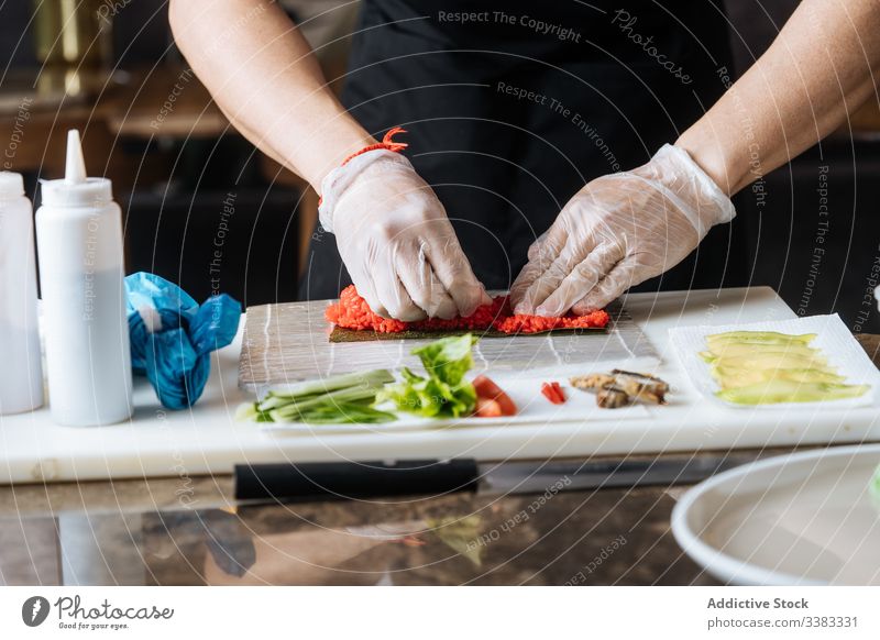 Cook preparing sushi on table with food ingredients seafood preparation cook fresh delicious dish yummy tasty fish roll oriental appetizer asian various