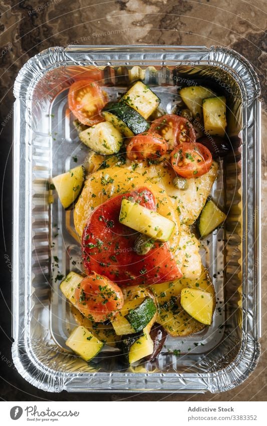 Colorful vegetables with herbs in shiny baking form tomatoes zucchini delicious meal sauce food healthy nutrition fresh tasty lunch dinner cuisine dish gourmet