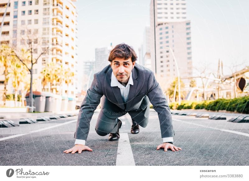 Businessman on a starter line with a city background asphalt barcelona begin beginner business businessman career challenge competition competitive competitor