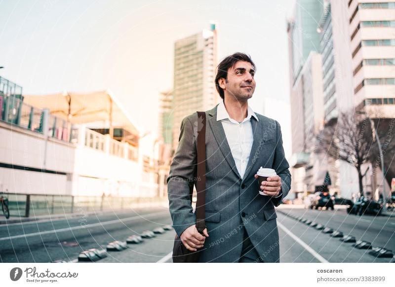 Happy businessman with a coffe on the city adult attractive barcelona blue broker caffeine casual caucasian ceo coffee corporate cup drink drinking employee