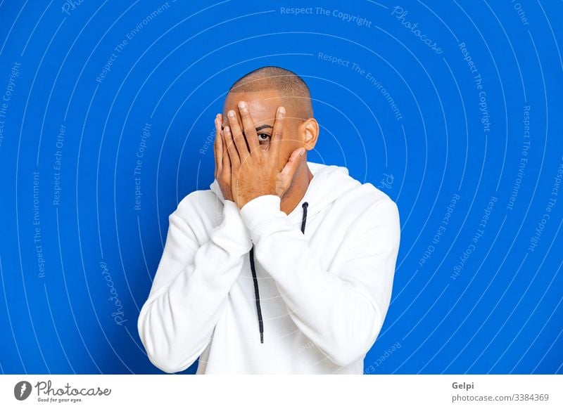 African guy wearing a white sweatshirt black blue sorry afraid fearful excited nervous adult people person african male american man isolated background studio