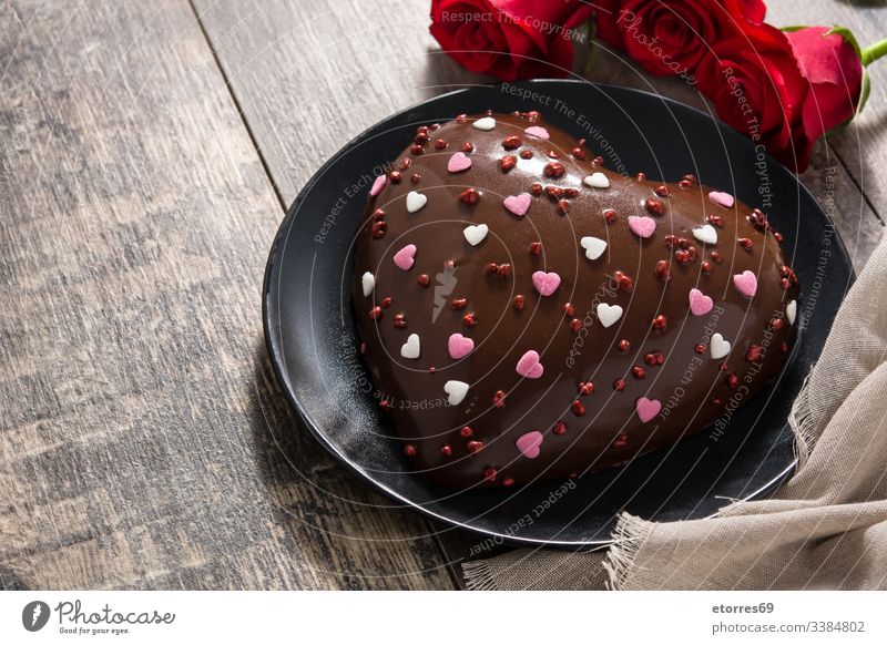 Heart shaped cake and red roses on wooden table baked bakery black chocolate cooked cut out delicious dessert flavor food heart holiday homemade love