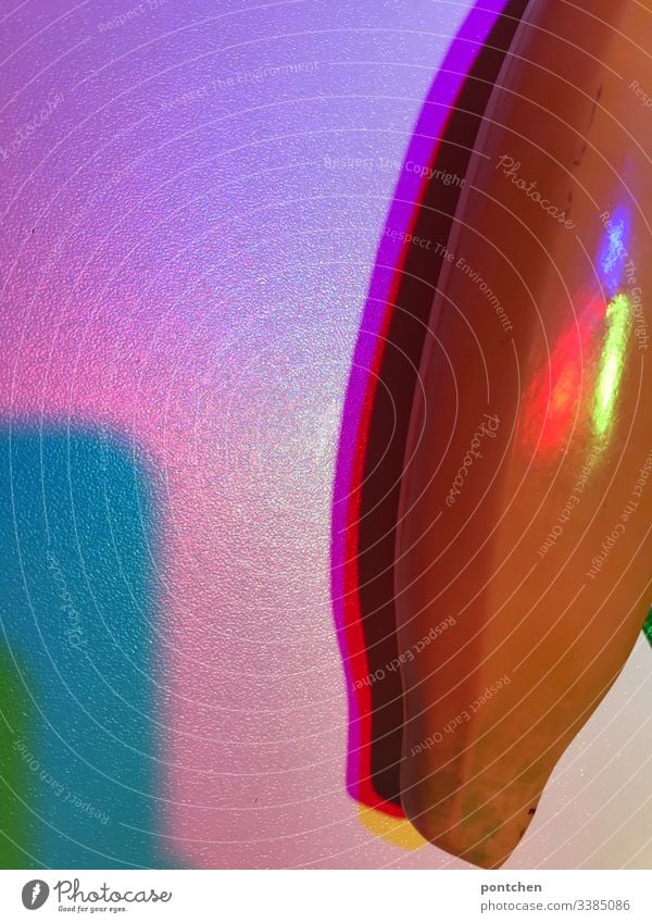 Coloured light at the light table falls on a banana Light variegated Rainbow Banana Artificial plastic pink Blue Green purple Red Shadow Experimental reflection