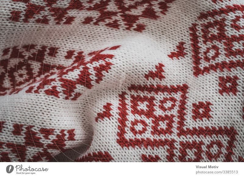 Detail of scandinavian red motifs industry textured cardigan fashion background surface design abstract closeup nobody detail knitwear knit up clothing material