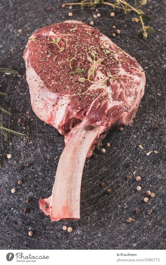 Tomahawk steak - raw beef BBQ Raw Steak Tomahawk Steak Meat Beef Cattle spices Holiday season Barbecue (apparatus) Fat Animal Nutrition Close-up Colour photo