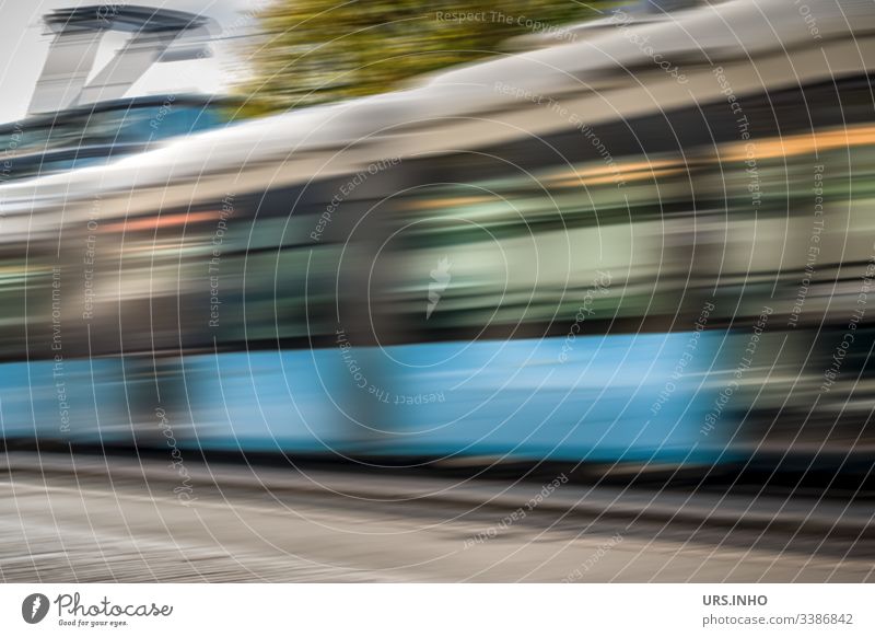 moving tram with motion dynamics Motion blur Driving travelling suburban railway Tram Day pass Movement move Blue Gray green swift blazing fast Dynamic
