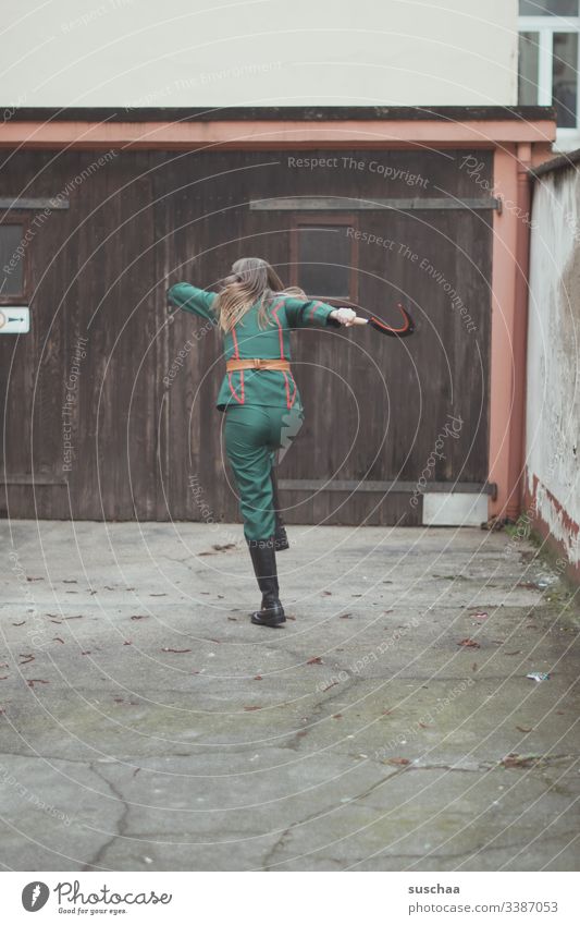 teenager stands in front of wall with uniform and hammer in hand Photochallenge Youth (Young adults) Uniform Tool Costume cladding Carnival carnival Whimsical