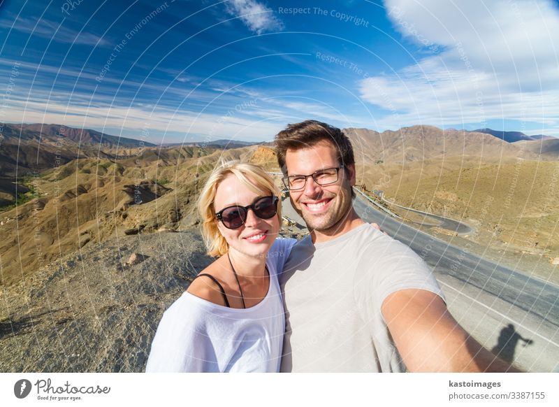 Active happy couple taking selfie on travel in high Atlas mountains, Ouarzazate, Morocco. adventure morocco portrait fun desert architecture moroccan marrakesh