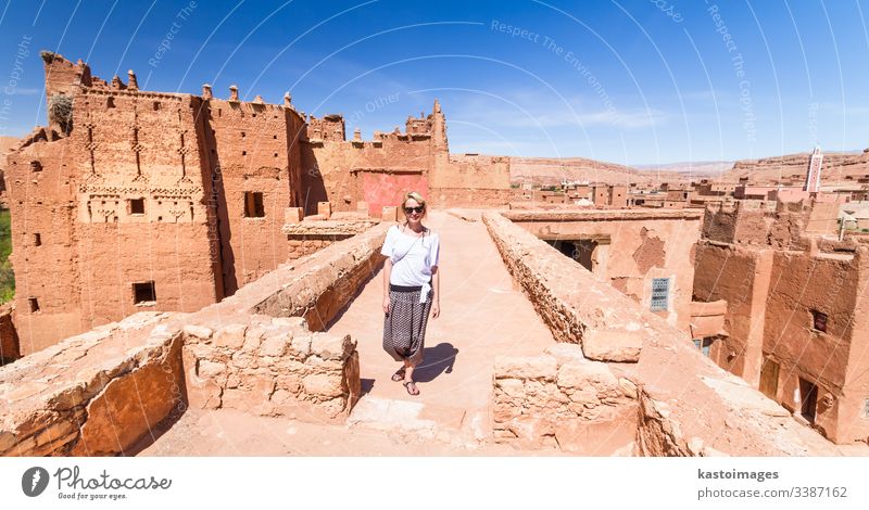 Woman on travel at Ait Benhaddou kasbah, Ouarzazate, Morocco. woman traveler backpacker adventure morocco portrait fun desert architecture moroccan marrakesh