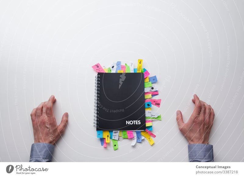 Top view of a man in front of a note pad full of sticky notes adhesive analysis appointment brainstorm brainstorming business busy collaboration color concepts
