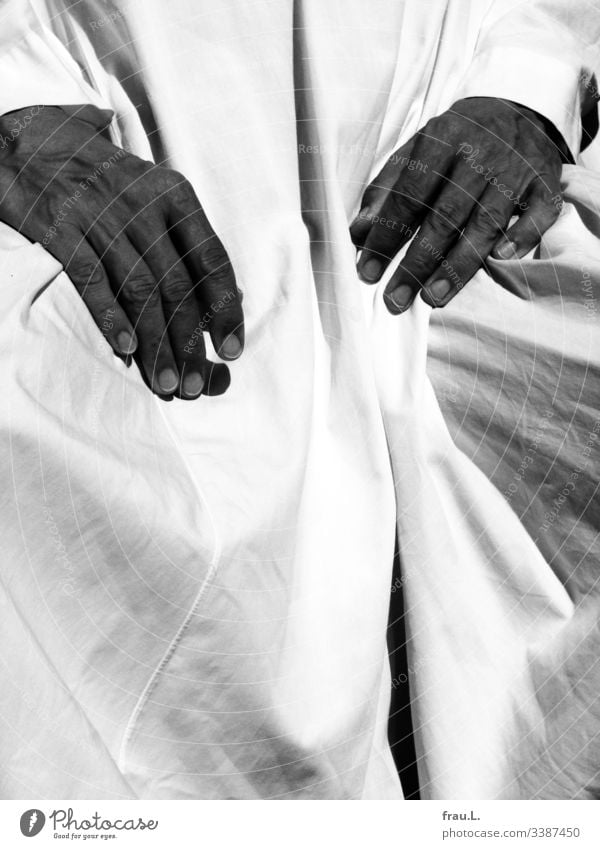 The white cotton fabric wrinkled with enthusiasm when long, sun-tanned hands cast shadows on it. Cloth Folds White Chelaba Textiles Dress Sunlight Man