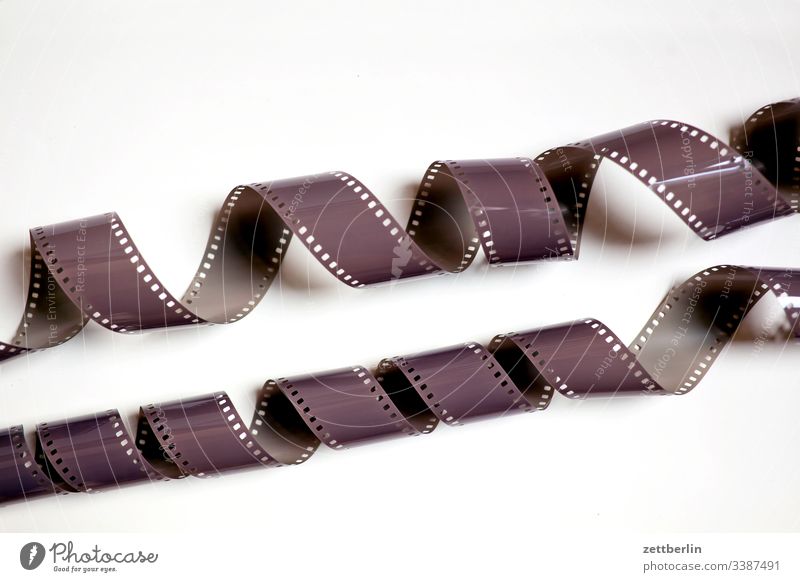 Strip of old celluloid film, Old photographic film, negative on blue  background Stock Photo