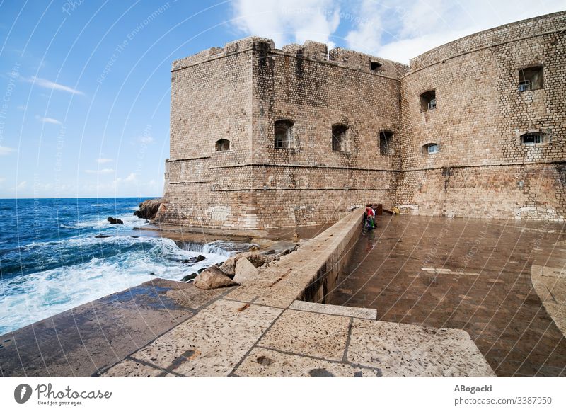 Dubrovnik Old Town Fortification And Pier dubrovnik wall fortification medieval architecture bay coast adriatic sea water stone exterior landmark croatia europe