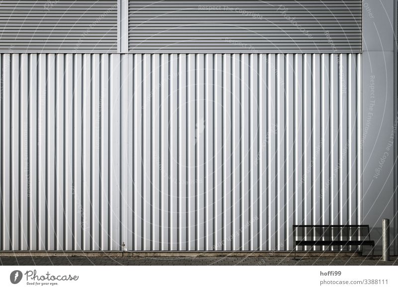 Bench with ashtray in front of a metal wall - take a seat Industrial plant Wall (building) Ashtray Metal Steel Line Sit Wall (barrier) Architecture Facade