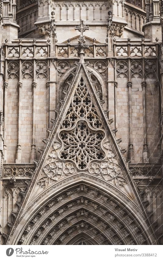 Rose window and sculpted filigrees at the front of a gothic cathedral rose window basilica architecture architectural carving sacred color outdoor outdoors