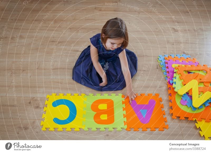 A young girl learning the alphabet abc activity bright caucasian child childhood color colorful concept copy space creative daughter development education