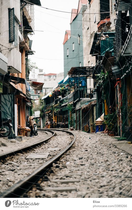 The landmark Train Street in Hanoi; train tracks that lead through a narrow alleyway, with apartment buildings and cafes Train tracks Railroad tracks Vietnam