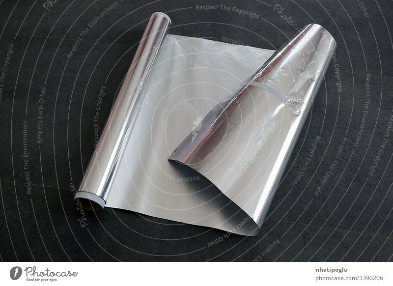 aluminum foil, rolled aluminum foil, close-up on a black background, paper isolated white bag blank packaging package plastic object food crumpled empty box