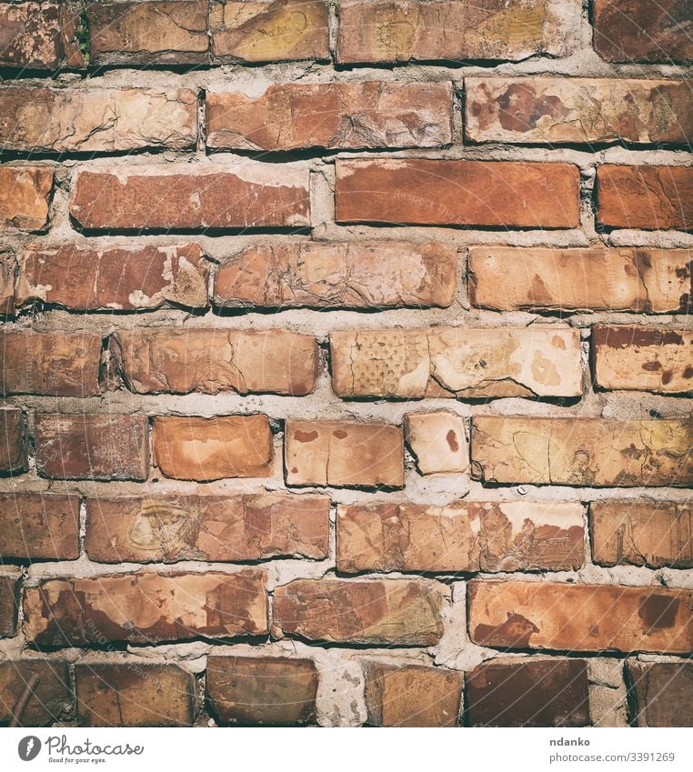 red brick wall with cement, fragment of architecture masonry old brown rectangular background rough construction material block stone building solid texture