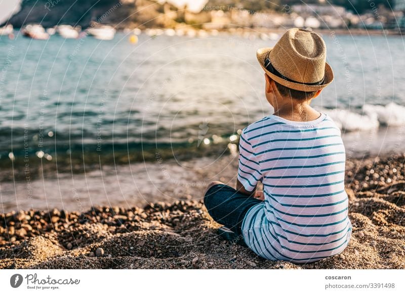 back view of little girl looking at sea - a Royalty Free Stock Photo from  Photocase