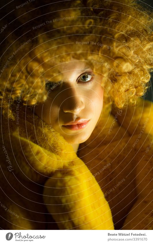 young woman with blond curls and yellow fake fur coat Make-up Makeup artist fashion stylisch streetart streetstyle Hip & trendy flur Flur coat beauty glamour