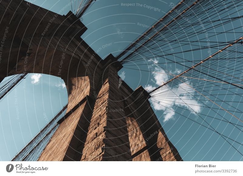 Brookly Bridge in New York Brooklyn Bridge Architecture Steel Stone Concrete Sky Clouds Goal piers Rope construction steel cable Pattern Light Shadow Transport