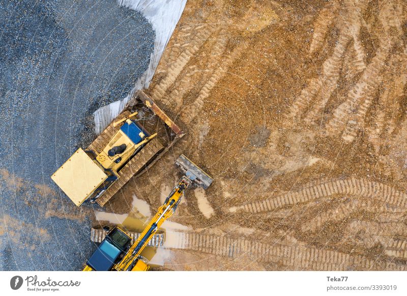 construction vehicle on an construction site from above excavator excavator from above Caterpillar Caterpillar from above modenr Caterpillar yellow mud water