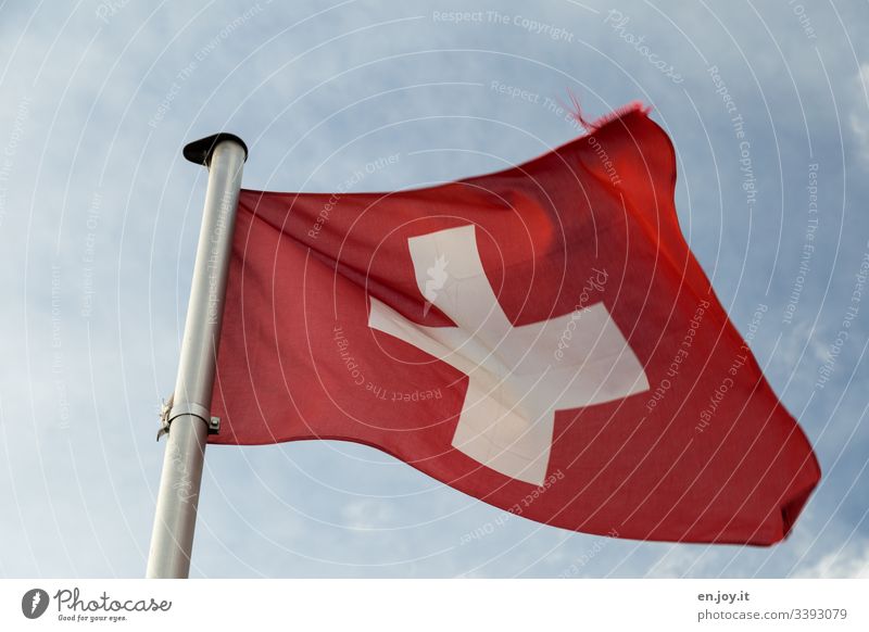 Swiss flag in front of cloudy sky Sky Clouds Flag Switzerland Red Crucifix White Blow Pole Flagpole Wind