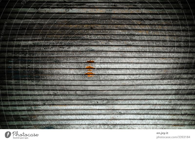 Closed garage door with a rust stain Warehouse Part of a building Industry Factory Goal Highway ramp (entrance) Aluminium dirt Old Roller shutter Garage door