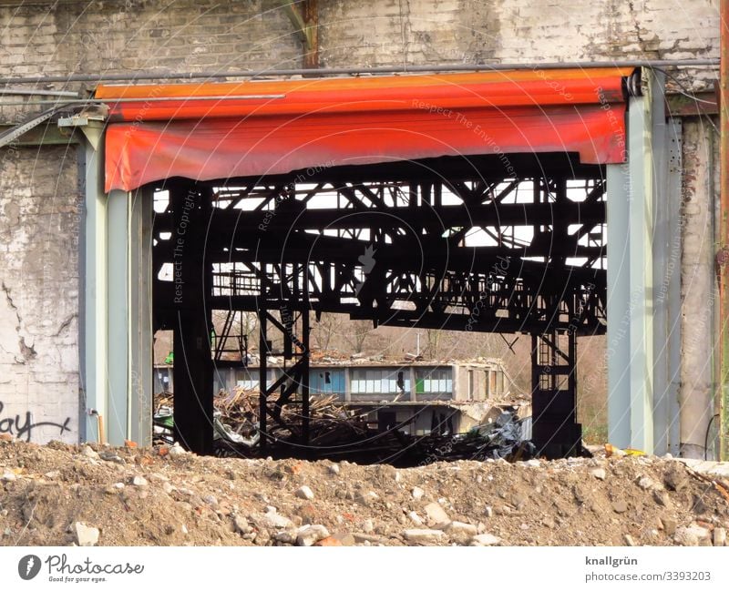 Industrial ruin with large gate with red tarpaulin Industrial wasteland Deserted Industrial plant Old Exterior shot Decline Colour photo Factory Day Building