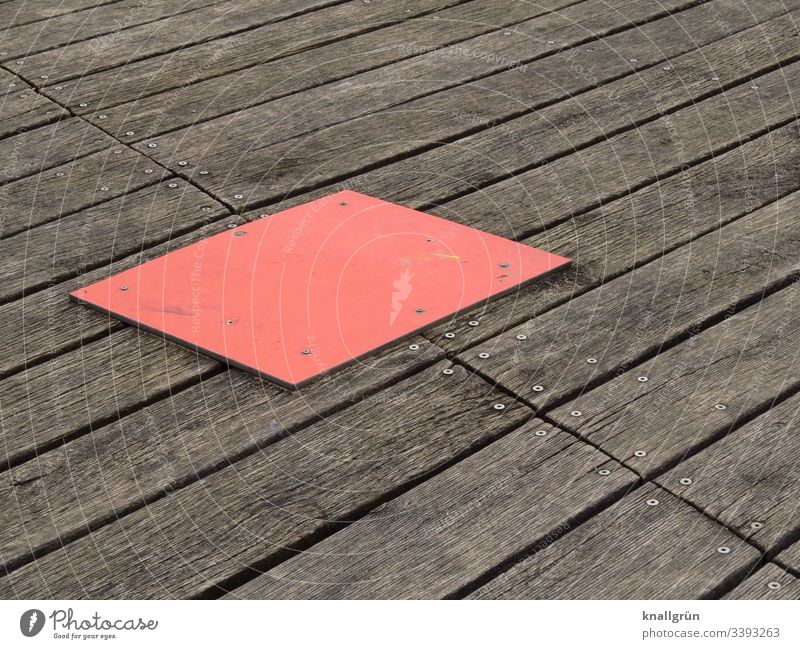 red rectangular cover plate on screwed wooden floor boards Wood Wooden board Red Brown Structures and shapes Deserted Exterior shot Colour photo Day Pattern