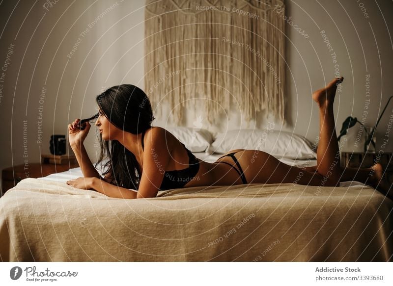naked woman lying on bed with panties around her ankles - a Royalty Free  Stock Photo from Photocase