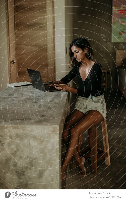 Focused young woman using laptop in room typing communication connection internet online surfing browsing device gadget female freelance work workplace