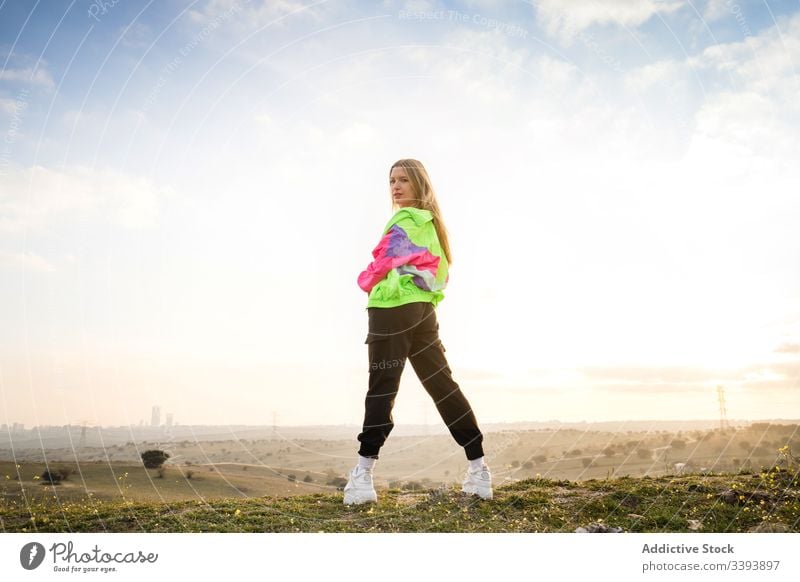 Female hipster in colorful clothes in countryside - a Royalty Free
