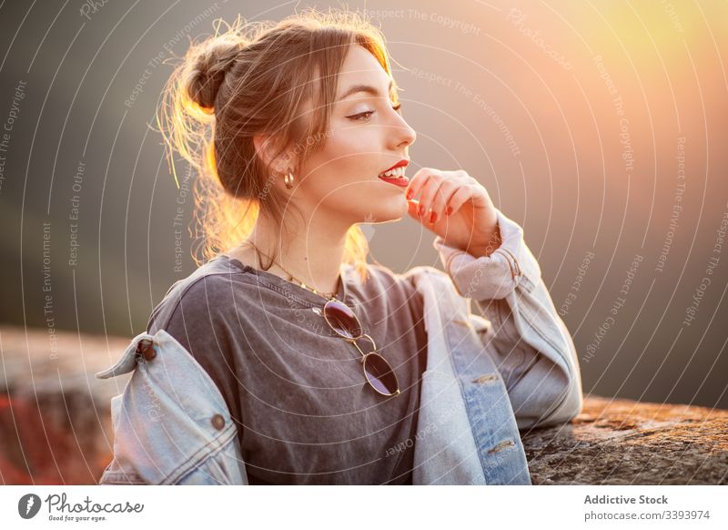 Stylish woman in casual wear delighting in view smile enjoy sun style trendy lifestyle harmony fashion rest relax outfit weekend contemporary young idyllic calm