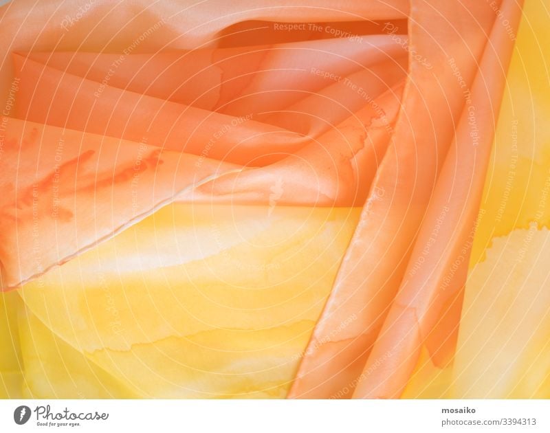 close up of hand colored orange and yellow silk scarf pongé watercolor waldorf acrylic aquarelle art artistic textile fabric silk painting background border