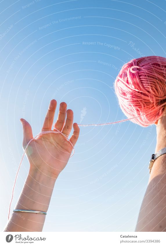 Hands holding a pink ball of wool against the sky hands Uphold Fingers Bangle Wool Ball of wool Sky Summer Blue Pink Crochet Warmth Leisure and hobbies Knit