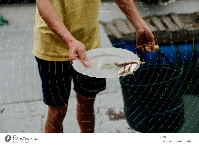 Fisherman is empty fish from net in his small boat - a Royalty Free Stock  Photo from Photocase