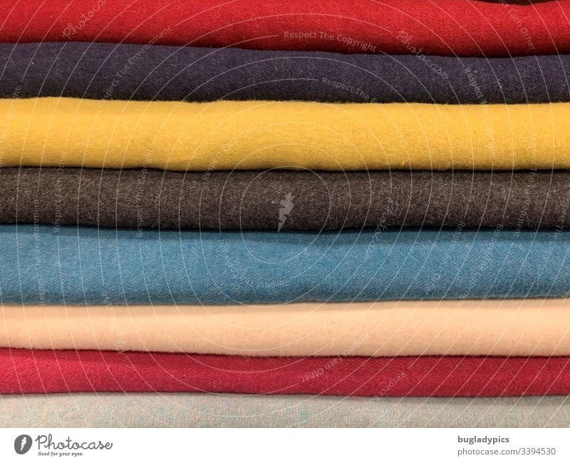 Different single-coloured fabrics (yellow, blue, red, beige, grey) placed on top of each other Cloth Wool Woollen goods motley Multicoloured variegated Close-up
