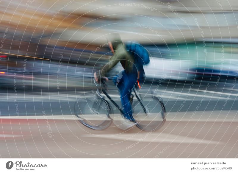 man ciclyng, bicycle mode of transport on the street in Bilbao city Spain bike transportation cycling cyclist biking biker exercise ride speed fast blur blurred