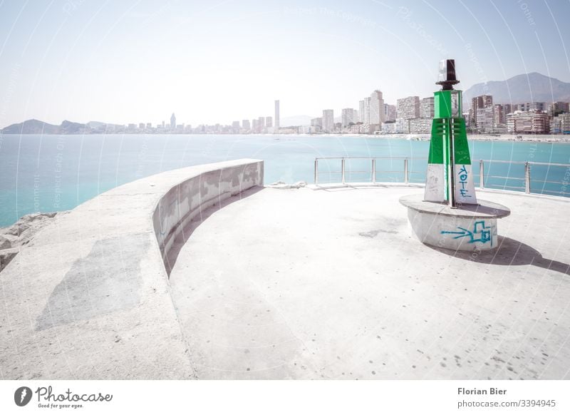 Lighthouse in the harbour with view of high-rise beach panorama over the sea Concrete Harbour Skyline Ocean High-rise graffiti dwell harbour bottom Beach Life
