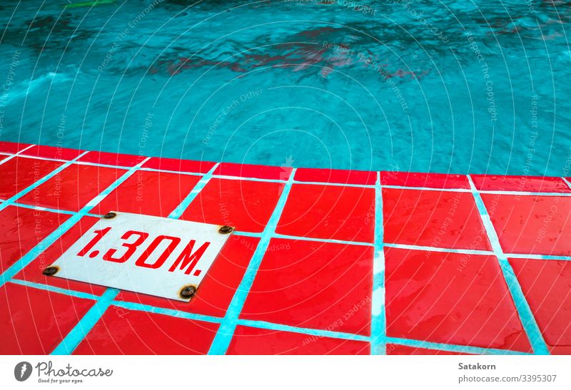 Deep level sign on the border of swimming pool water mark deep number indicator meter depth outdoors surface blue tile red Swimming pool Surface of water