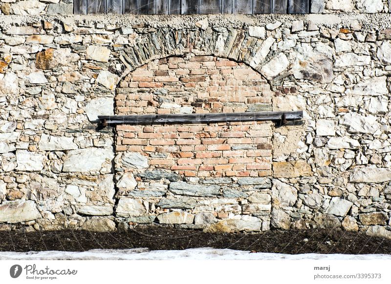 A stone wall with a bricked-up gateway additionally secured with a beam. Expertly walled archway. lockdown Stone wall Wall (barrier) Archway Door protection