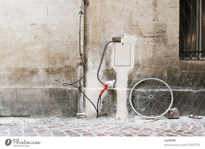 creative electrical installation / creative house connection at an old building with stone and bicycle rim Electrical equipment Electronics Dirty streams