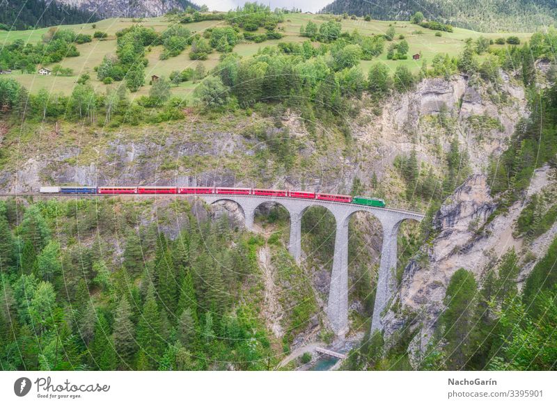 Red express train runs on famous Landwasser bridge in Filisur, the heart of Alpine mountains in Switzerland landwasser swiss switzerland nature architecture