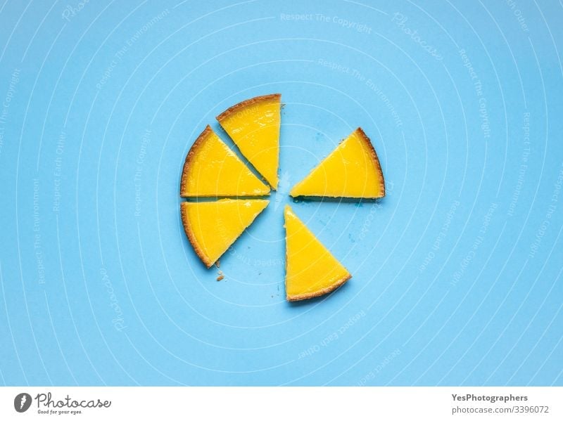 Sliced lemon pie on blue background. Fruit tart slices above view citrous tart colorful cuisine delicious dessert eating flat lay fruit cake isolated lemon tart