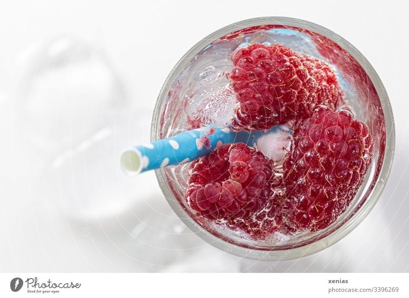 Cool refreshing drink with raspberries, ice cubes and drinking straw Close-up Delicious Red Cold Healthy Eating Cold drink Raspberry Fruit Ice cube Beverage