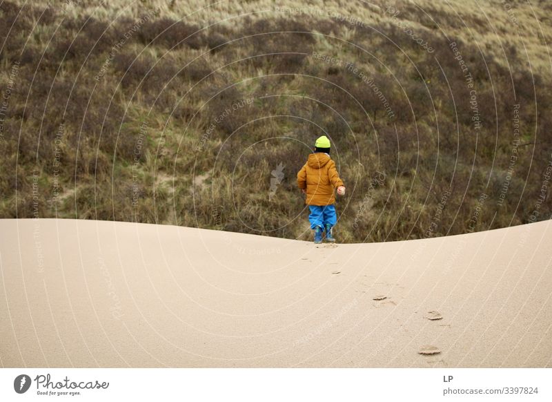 Boy running on sand dunes Sand Sandy beach Dune Vacation & Travel Beach dune Exterior shot Desert resilience difficult times Optimism Determination Brave Career